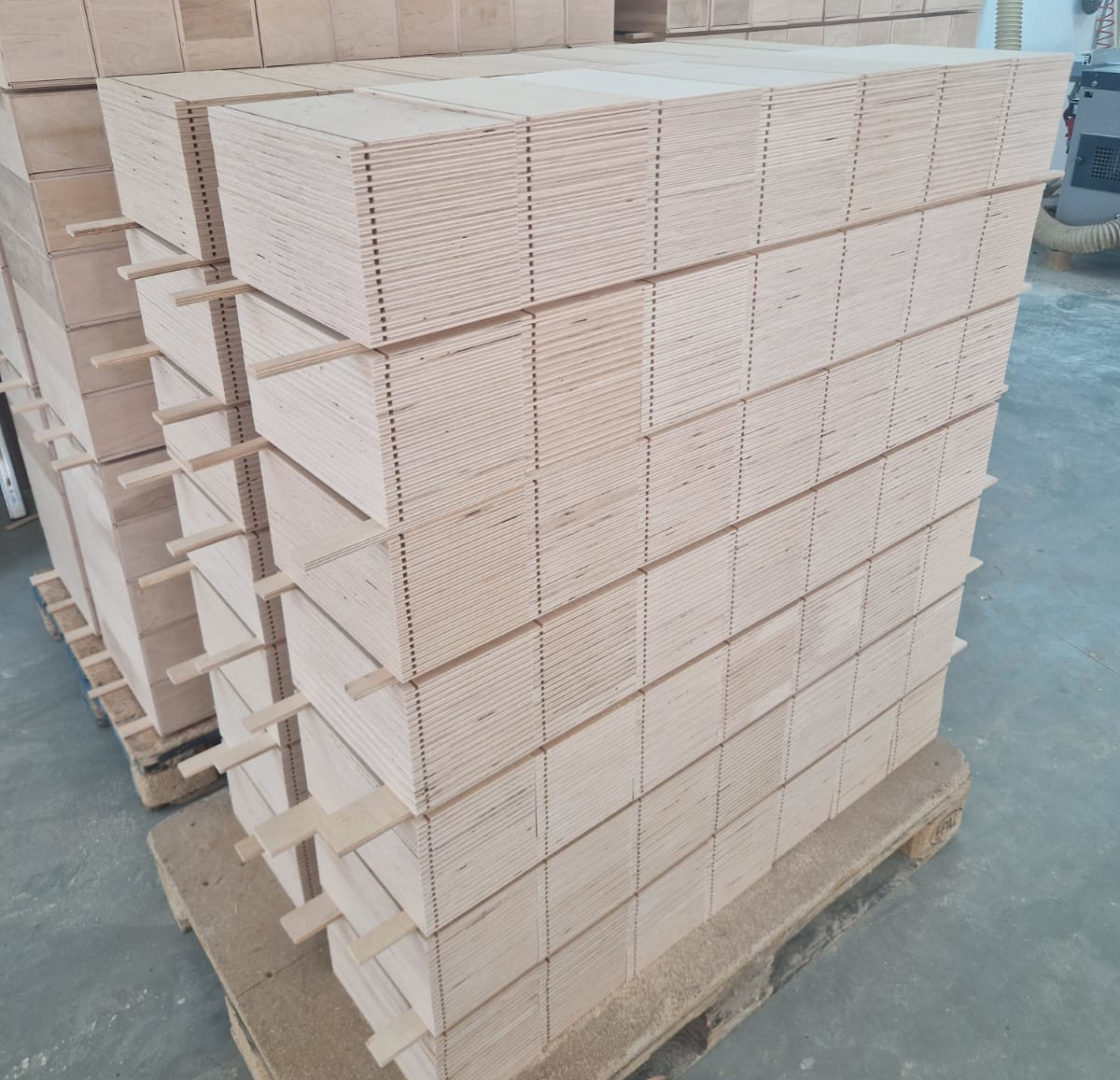 Stacked wooden panels on a pallet in a woodworking factory